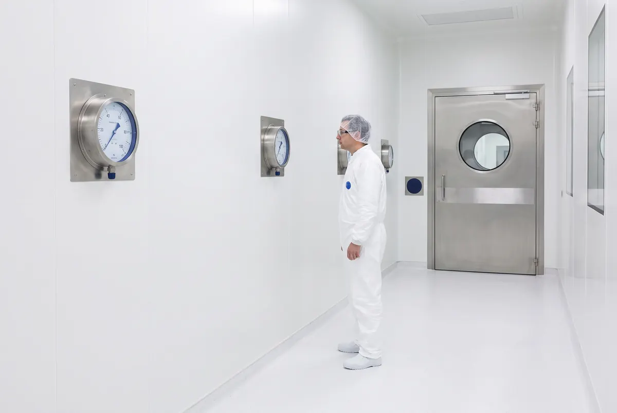 Newly commissioned GMP cleanroom suite with modular wall panels and coved epoxy flooring.